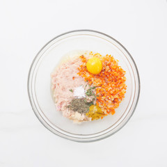 Chicken meat and vegetables on the white background. Cooking at home with fresh organic food. Healthy eating lifestyle.