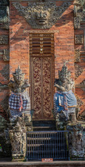 Ubud, Bali, Indonesia - February 26, 2019: Batuan Temple. Closeup of gray stone dwarapalakas,...