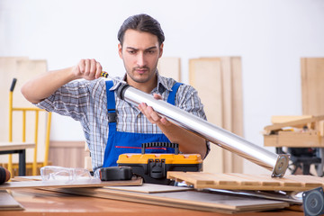 Young male carpenter working indoors 