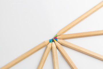 Color pencils are on the white table.