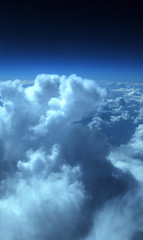 Fototapeta premium aerial view from plane, blue sky with clouds and sun
