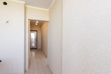 A long corridor in the apartment, going from the kitchen to the exit