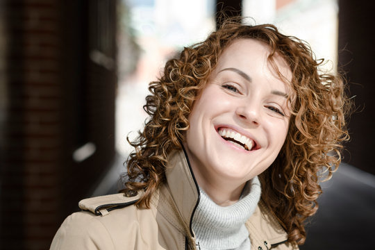 Portrait of laughing woman with curly hair