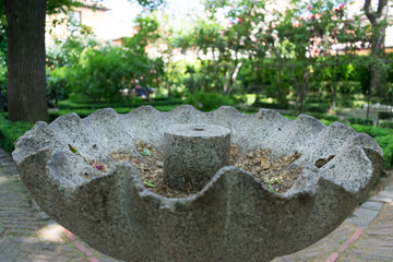 Closeup of old gray stone fountain in park