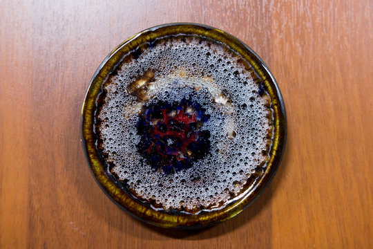 meeting potters. training courses for novice ceramists. reportage. ceramic example of clay saucer with melted colored glass. firing at 1200 degrees Celsius.