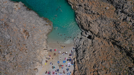 Aerial drone photo of heavenly turquoise rocky beach in shape of fjord of Seitan limania or Agiou Stefanou, Chania - Akrotiri, Crete, Greece