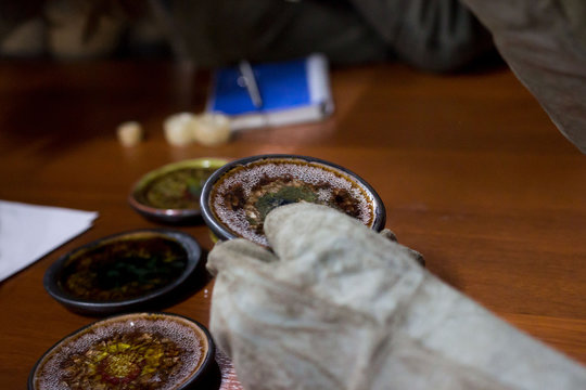 meeting potters. training courses for novice ceramists. reportage. ceramic example of clay saucer with melted colored glass. firing at 1200 degrees Celsius.
