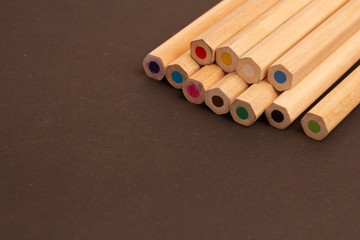 Color pencils lie diagonally with a blunt end on a black background