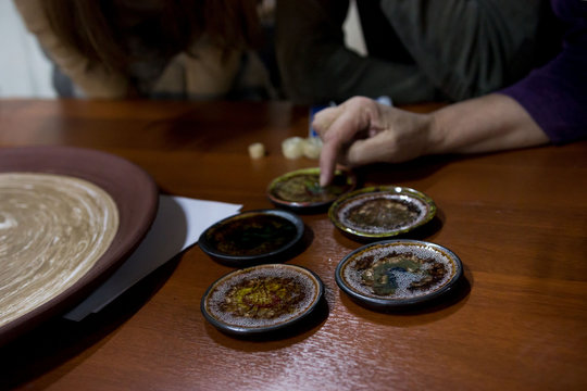meeting potters. training courses for novice ceramists. reportage. many ceramic examples of clay saucer with melted colored glass. firing at 1200 degrees Celsius.