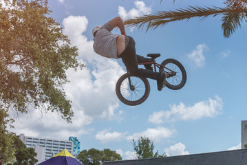 BMX Biker with a Big Air Jump at a Skatepark
