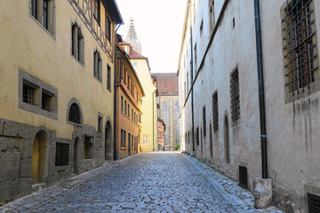 Fototapeta na wymiar Deserted narrow cobblestone street in medieval village in Germany