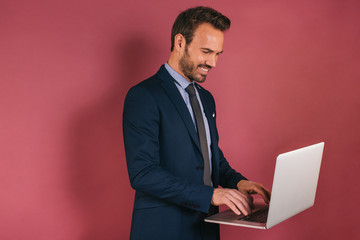 Handsome businessman working in a laptop