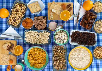 Corn flakes, walnuts, dried plums, dates, granola served in bowls