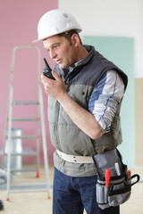construction worker speaking by walkie-talkie