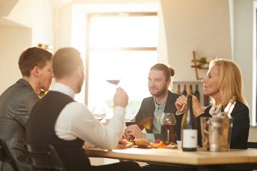 Group of business people enjoying wine during winery tour, copy space