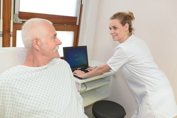 nurse using a laptop in the ward