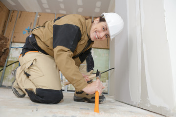 female builder using a hammer