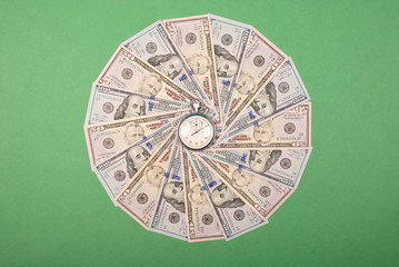Stopwatch on mandala kaleidoscope from money.