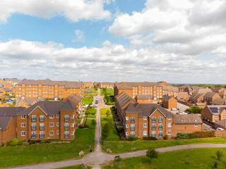 Aerial photo over looking the area of Leeds known as Beeston in West Yorkshire, showing the newly built housing estate taken on a sunny part cloudy day.
