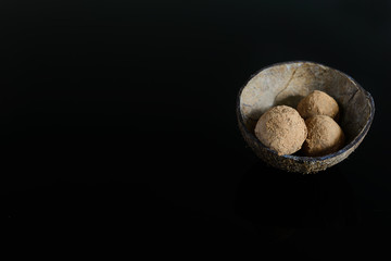 Energy balls of date fruitss and nuts. Raw dessert on a dark background.