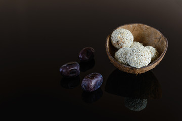 Energy balls of date fruitss and nuts. Raw dessert on a dark background.