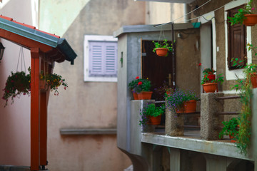 Fototapeta na wymiar Summer balcony with flowers in the mediterranean european city