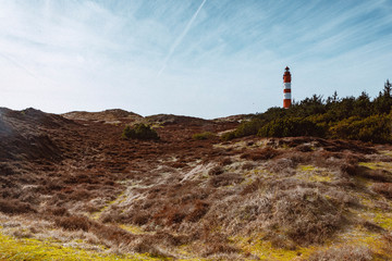 Red lighthouse on the hill in distance