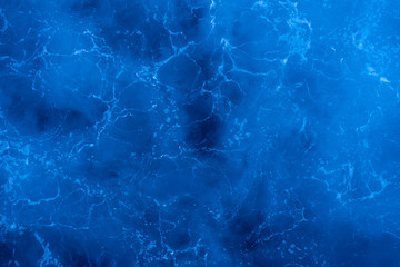 Dark blue deep sea surface, water with sea foam on a stormy day