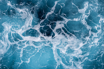 Rough deep turquoise and blue Mediterranean sea with white foam texture background