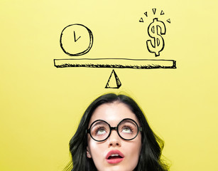 Time and money on the scale with young woman wearing eye glasses