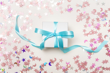 A gift box with confetti on a white background