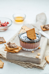 Liver pate with crisps on a white background. Selective focus.