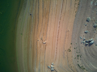 Aerial view of the Valdecañas reservoir, with green water from the algae and natural lines of the...