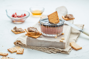 Liver pate with crisps on a white background. Selective focus.