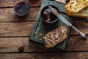 Bread with liver pate on wooden background, copy space
