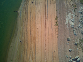 Aerial view of the Valdecañas reservoir, with green water from the algae and natural lines of the...