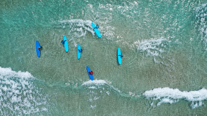 Aerial drone top view photo of young team of surfers enjoying tropical wavy turquoise sea sandy...
