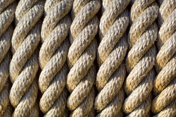 Twisted rope vertical texture, marine background. Old nautical objects concept.