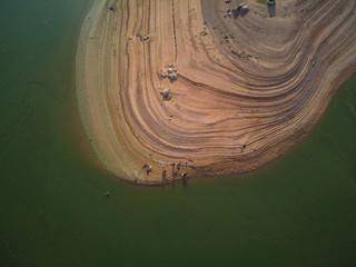 Aerial view of fishermen in the swamp of Valdecañas, with green water by algae and natural lines...