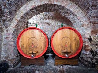 Oak barrels in an old underground wine cellar.