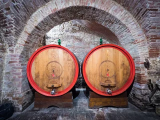 Fotobehang Oak barrels in an old underground wine cellar. © isaac74