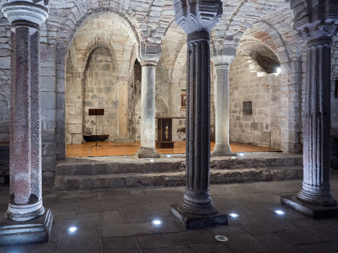 Crypt of a medieval abbey with carved stone columns.