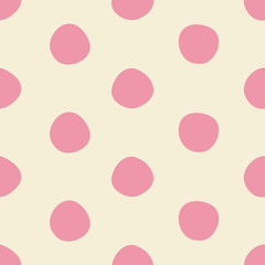 Cute pink dots seamless pattern in pink and light beige. Imperfectly round polka dot all over print design is great for fashion, textiles, wallpaper, gift wrapping paper and home decor items. Vector. 