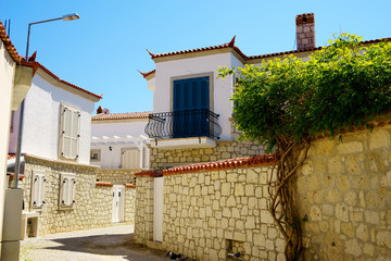 close up narrow street and old houses in little town Alacati of Izmir, Turkey