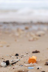 Plastic waste on a sand beach. 