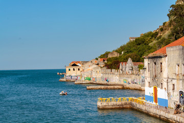 Almada, Portugal: CIRCA May 2019: Old and abandoned warehouses at Ginjal Pier in Cacilhas, Almada