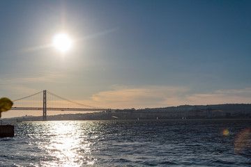 Fototapeta na wymiar Tagus River and Lisbon 25 of April bridge at sunset