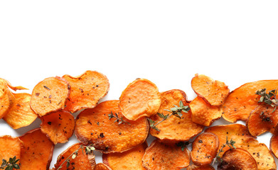 Sweet potato chips with herbs on white background, top view
