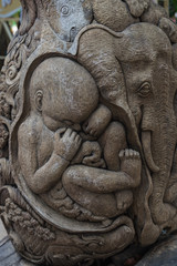 Fototapeta na wymiar Thai elephants carved on old wood at public temple