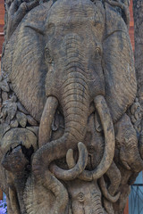 Thai elephants carved on old wood at public temple